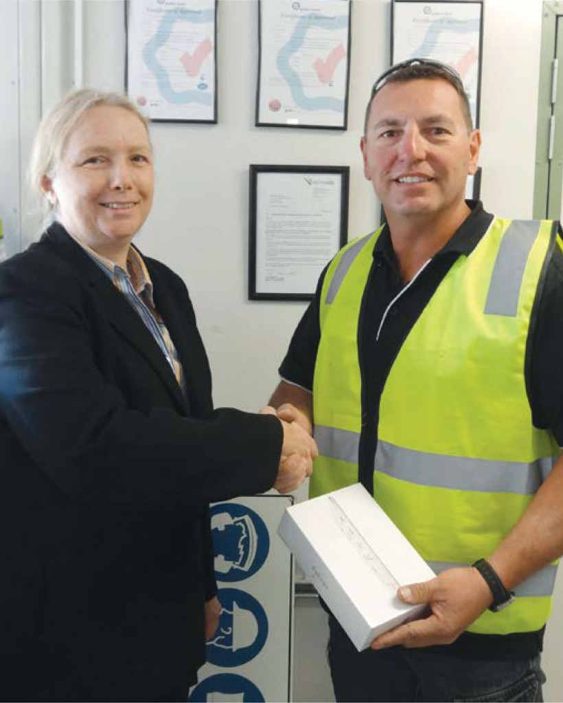PHOTO: Dr Elizabeth Gibson presents Mark Stalio of Aurora Constructions with the Mini iPad.