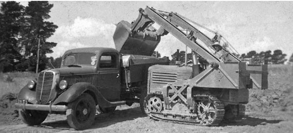 Truck loading in the 1930's with a then modern hydraulic crawler tractor